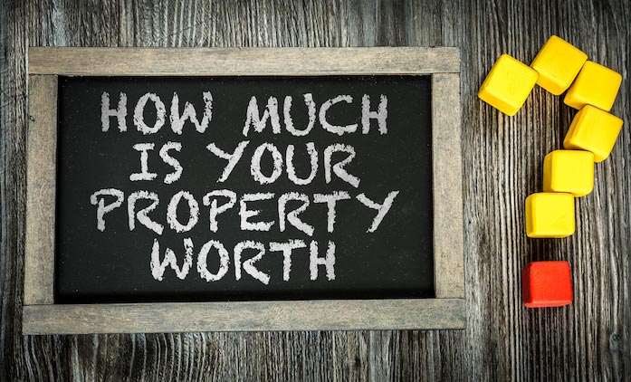Blackboard with the text: How much is your property worth? on it